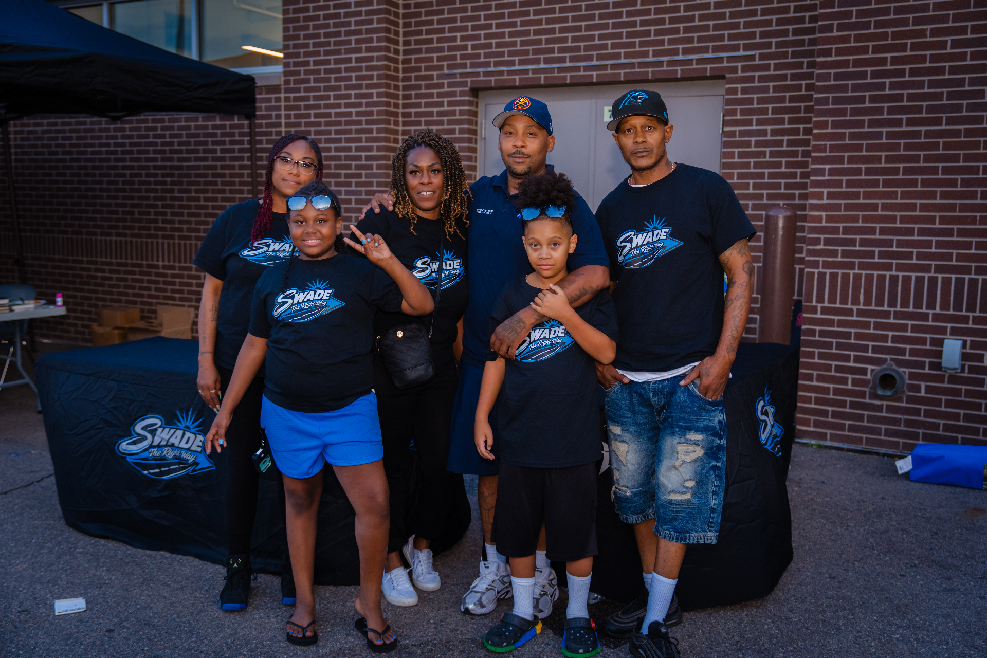 SWADE volunteers in matching shirts posing together at the Back to School drive